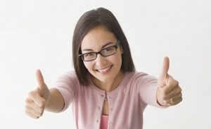 Mixed race businesswoman giving thumbs up